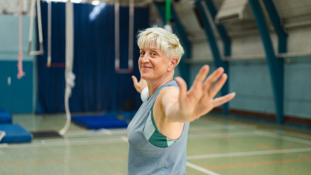 Healthy adult hiking or practicing yoga outdoors, with sunlight streaming in—visual representation of mitochondrial health through lifestyle Healthy adult hiking or practicing yoga outdoors, with sunlight streaming in—visual representation of mitochondrial health through lifestyle