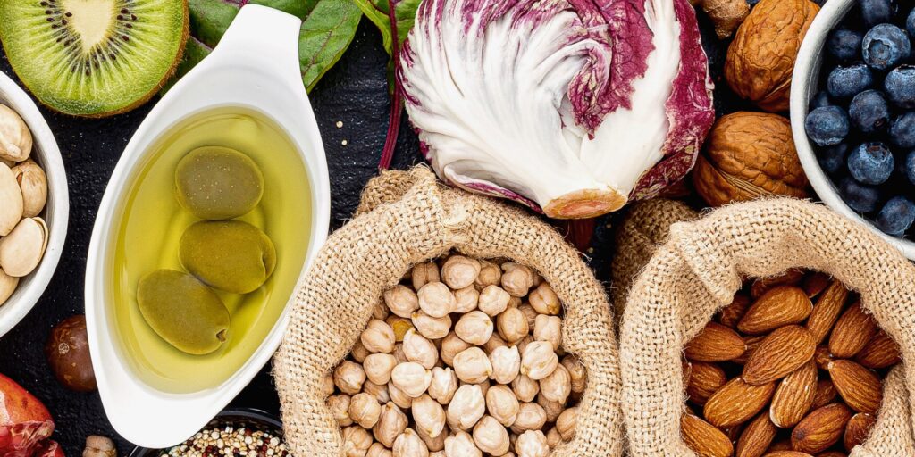 Variety of nutrient-rich foods for winter immune support including berries leafy greens nuts and citrus